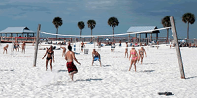 Young adults playing volleyball on the soft sand at Clearwater Beach image
